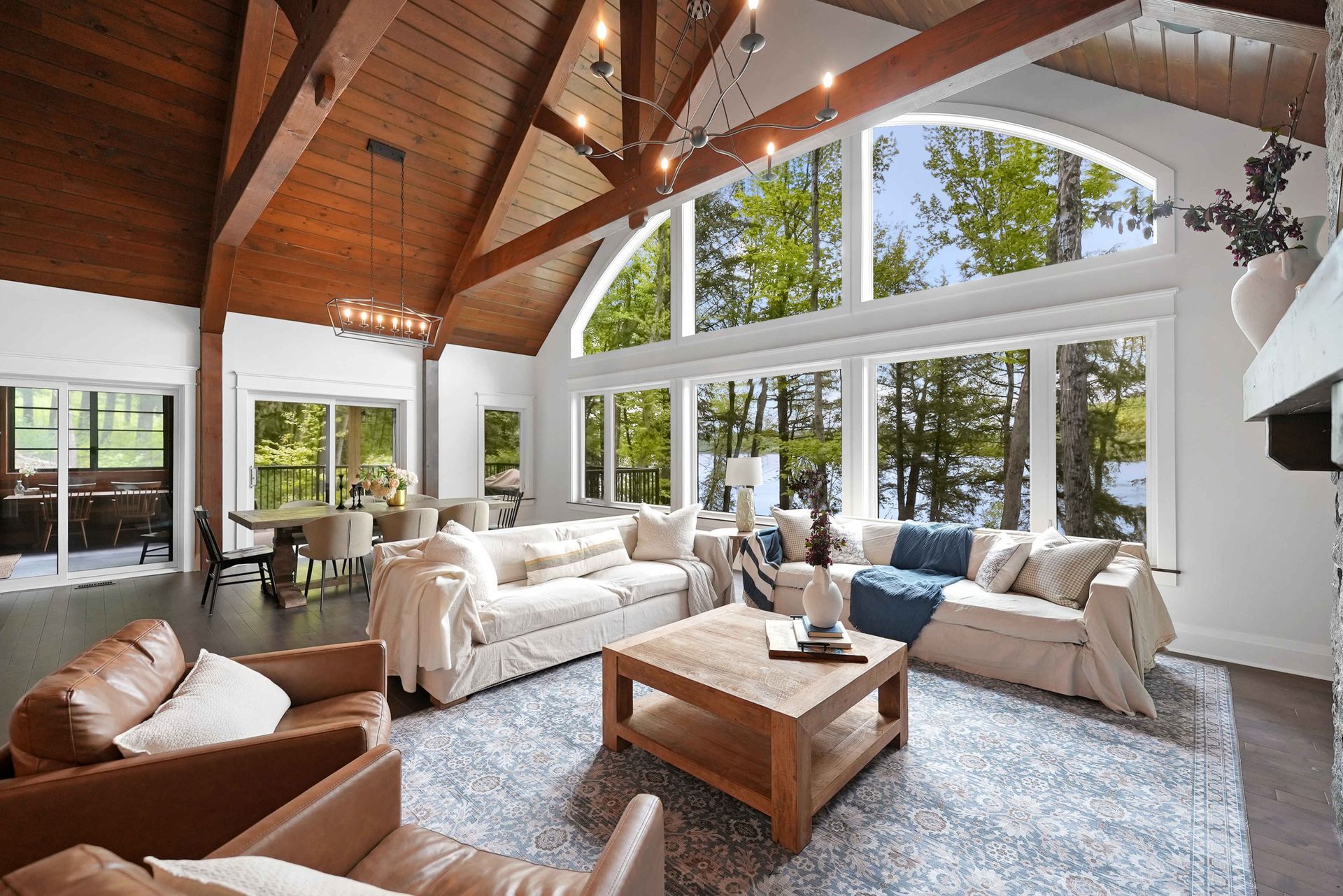A living room with a fireplace and lots of windows