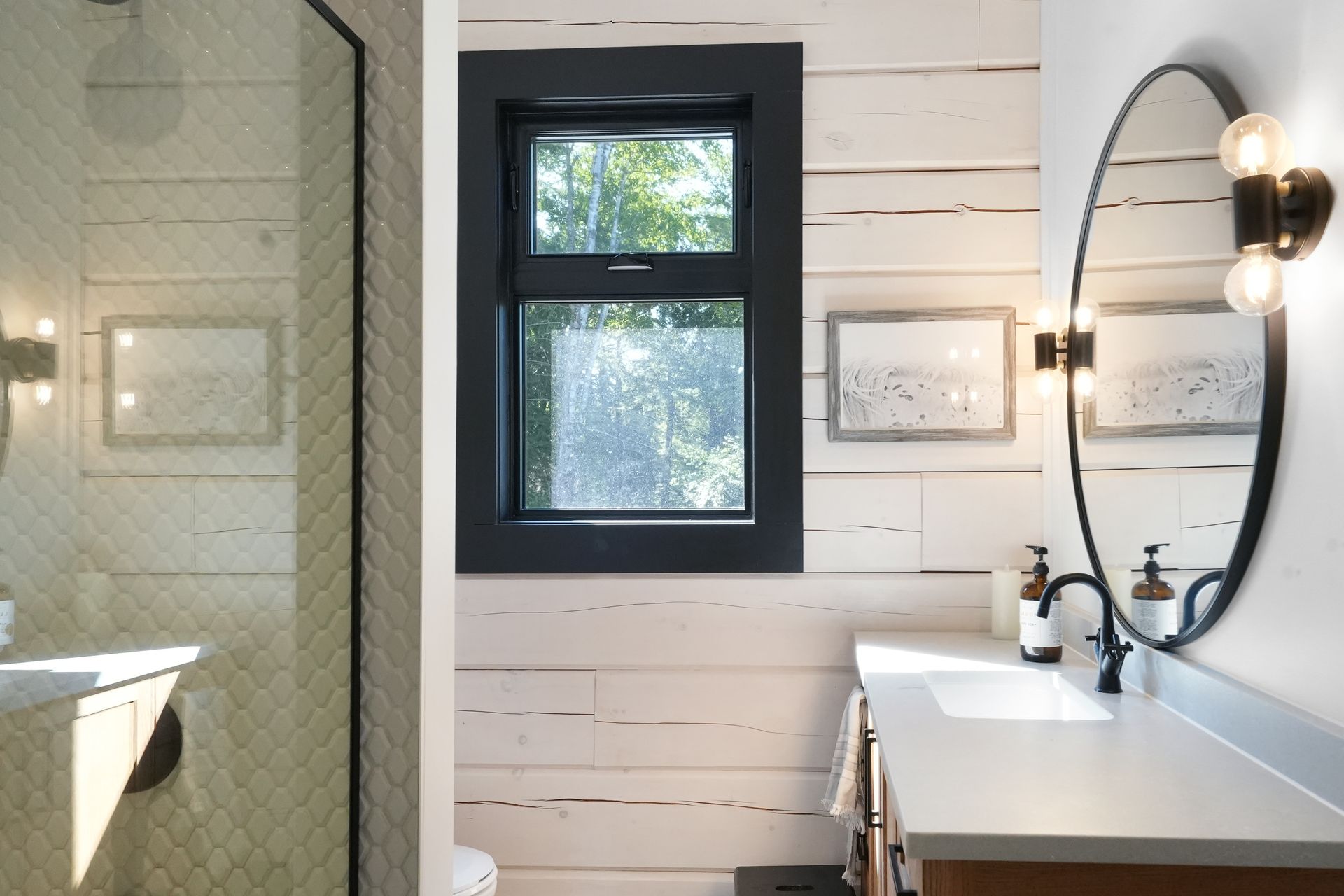 A home gym with a wooden floor and a lot of exercise equipment.