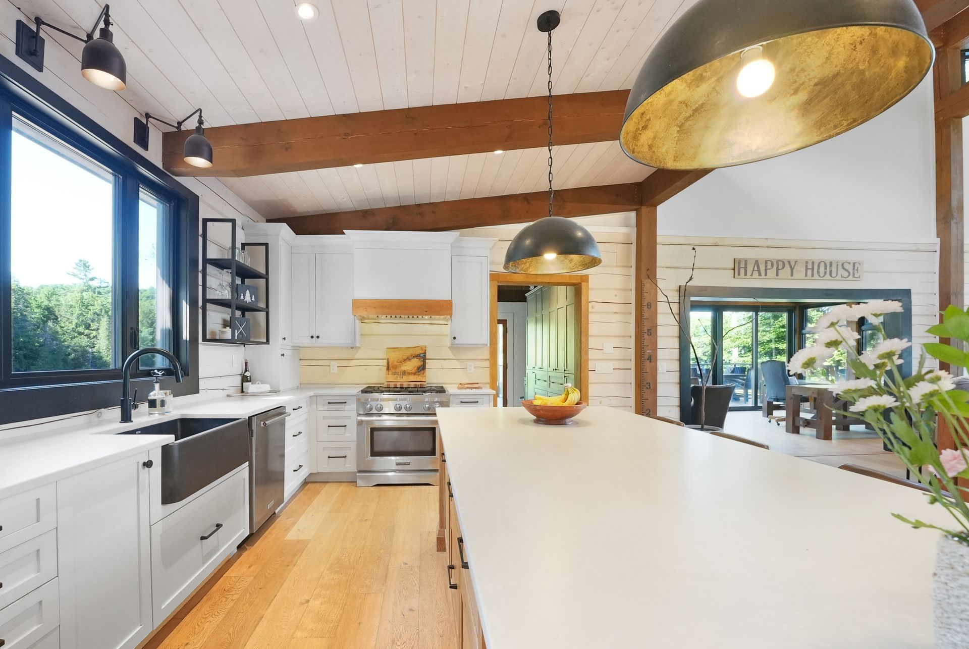 A living room with a lot of windows and a ceiling fan.
