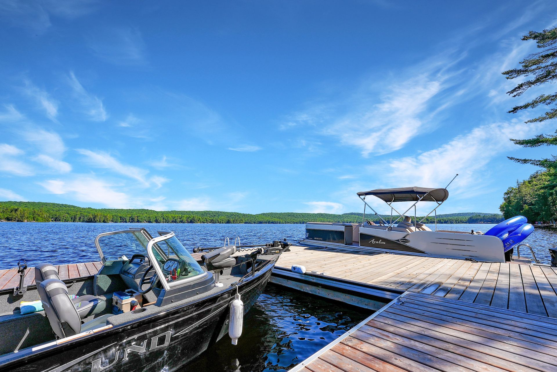 A boat is docked at a dock on a lake