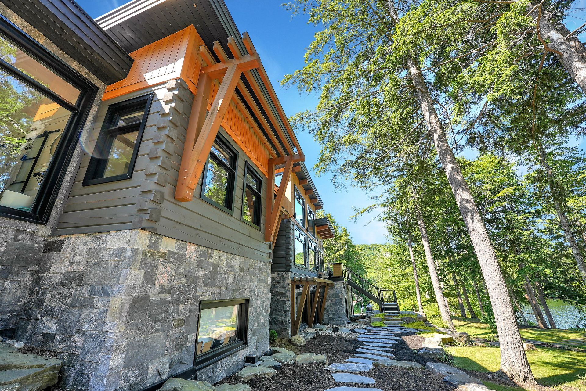 A bedroom with a king size bed and lots of windows