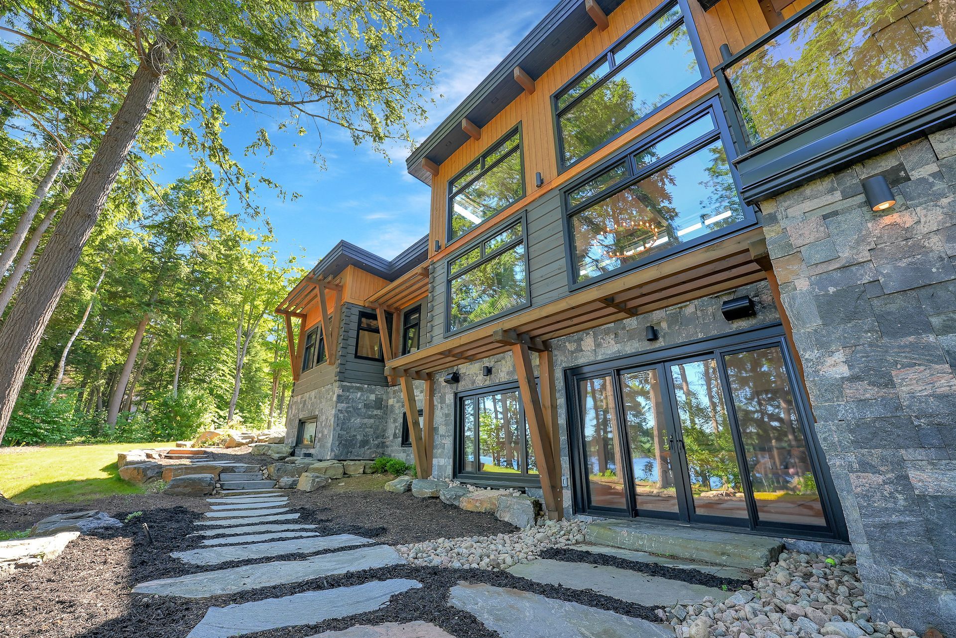 A large house with a large deck and stairs leading up to it.