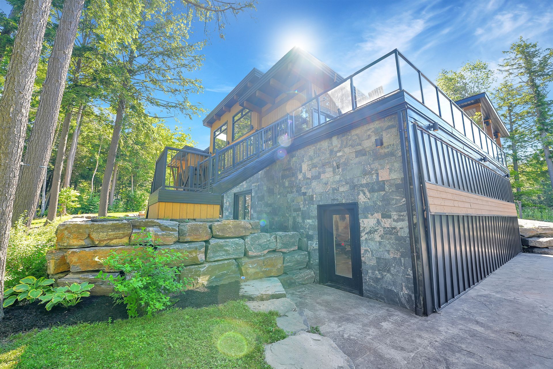 A large house with a lot of windows is surrounded by trees