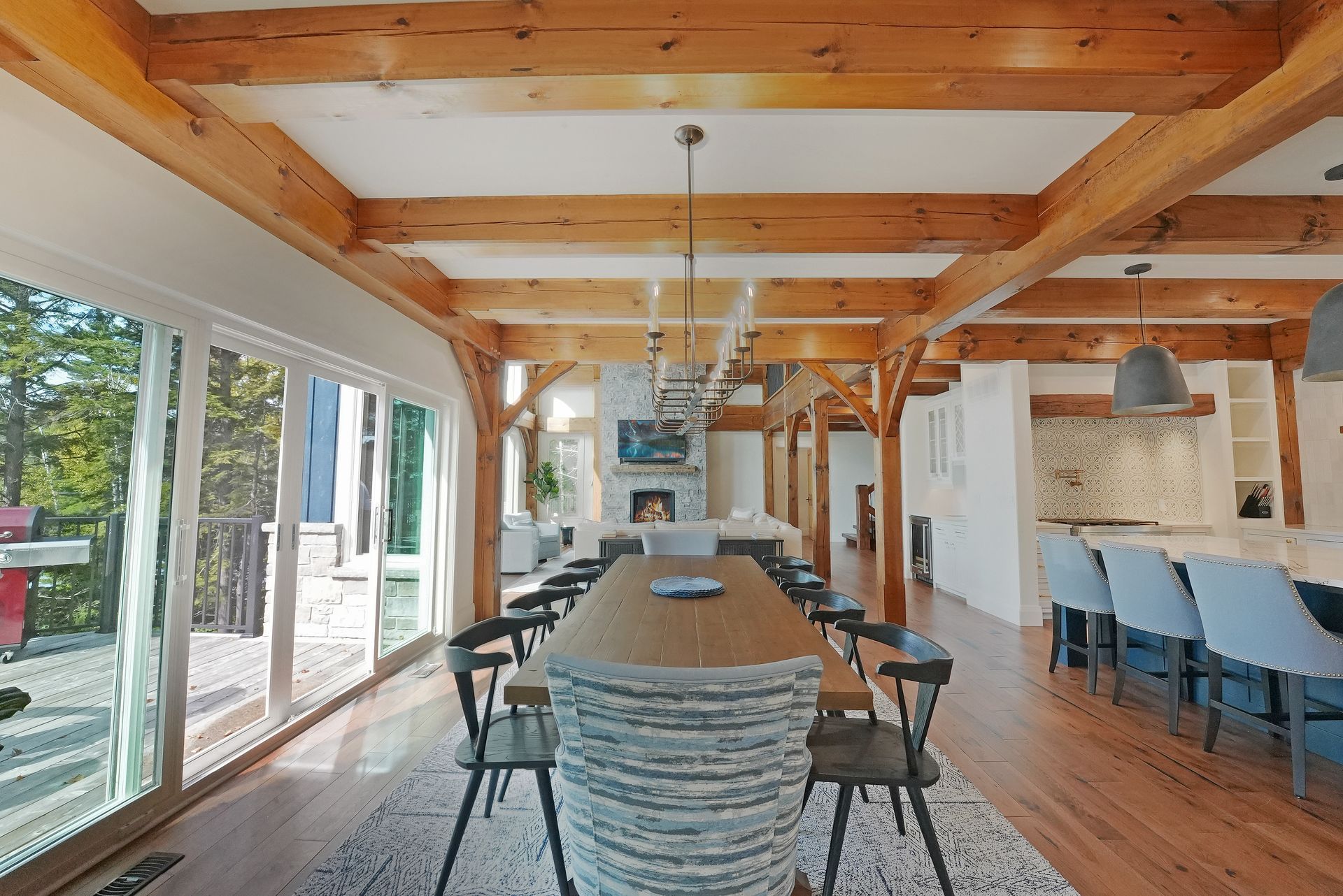 A large wooden dining room with a long wooden table and chairs.