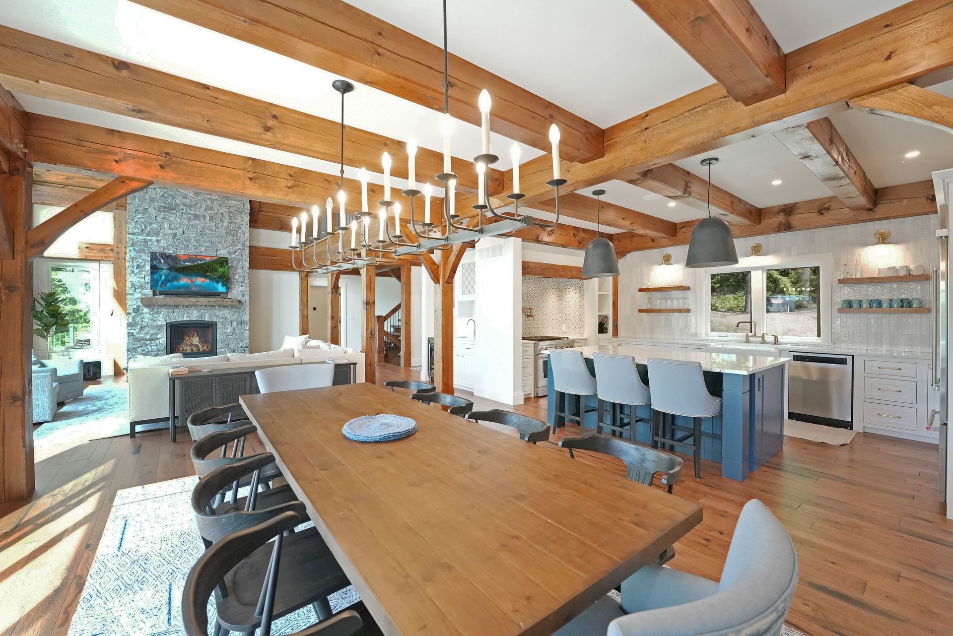 A large wooden dining room with a long wooden table and chairs.