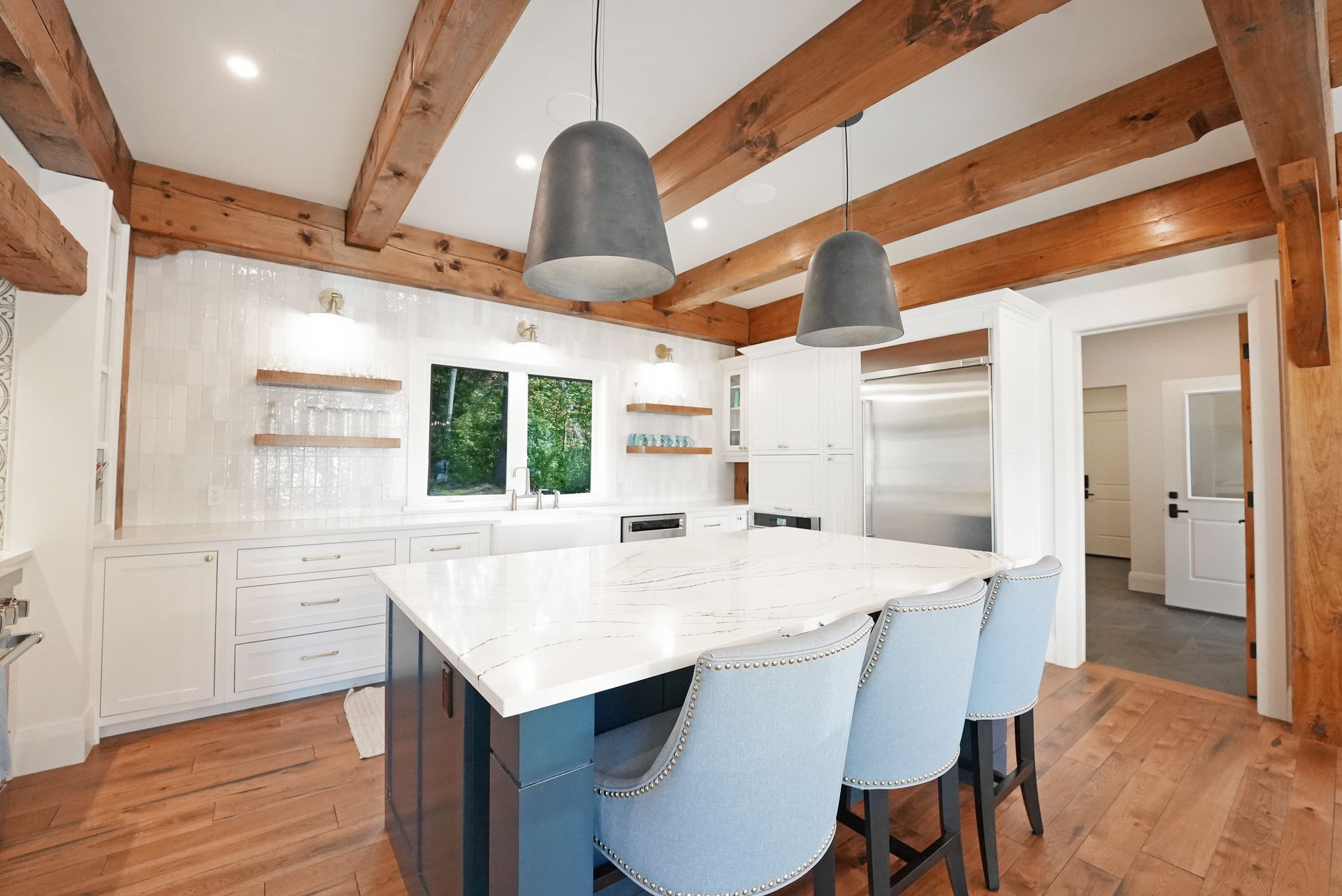 A kitchen with wooden cabinets and a large island