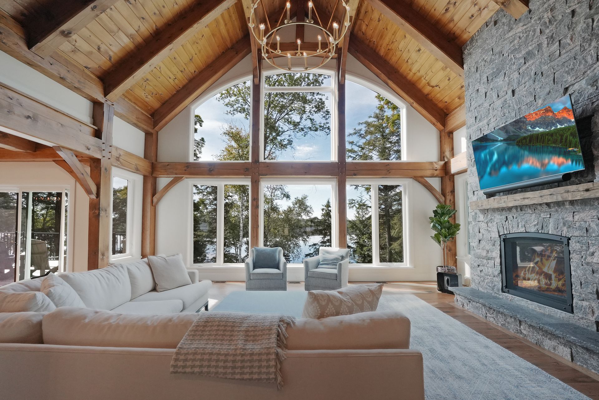 A living room with a fireplace and lots of windows