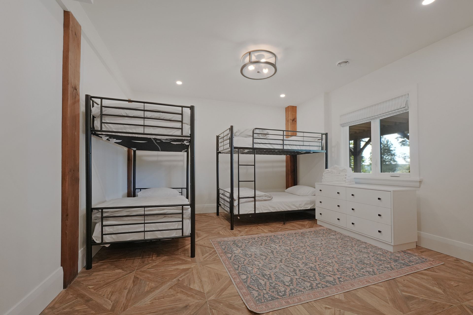 A bedroom with a king size bed and a wooden ceiling.