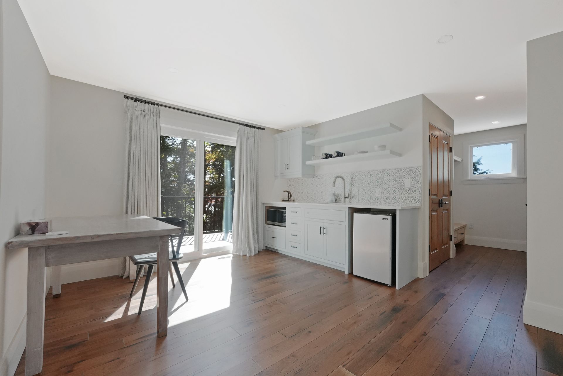 A bathroom with a toilet , sink , mirror and walk in shower.