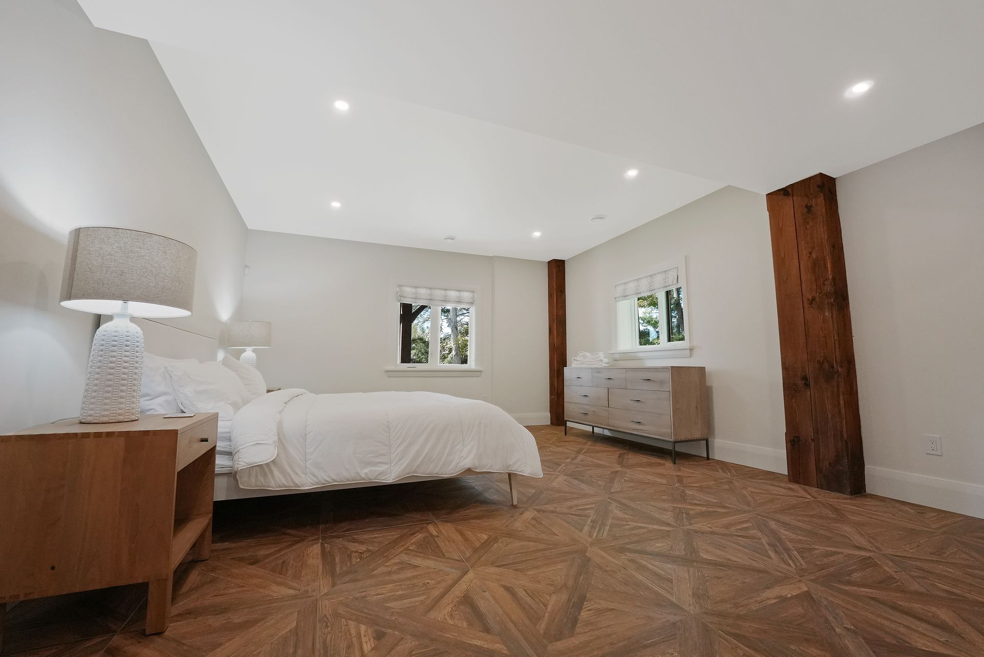 A bedroom with a large bed and a large window.