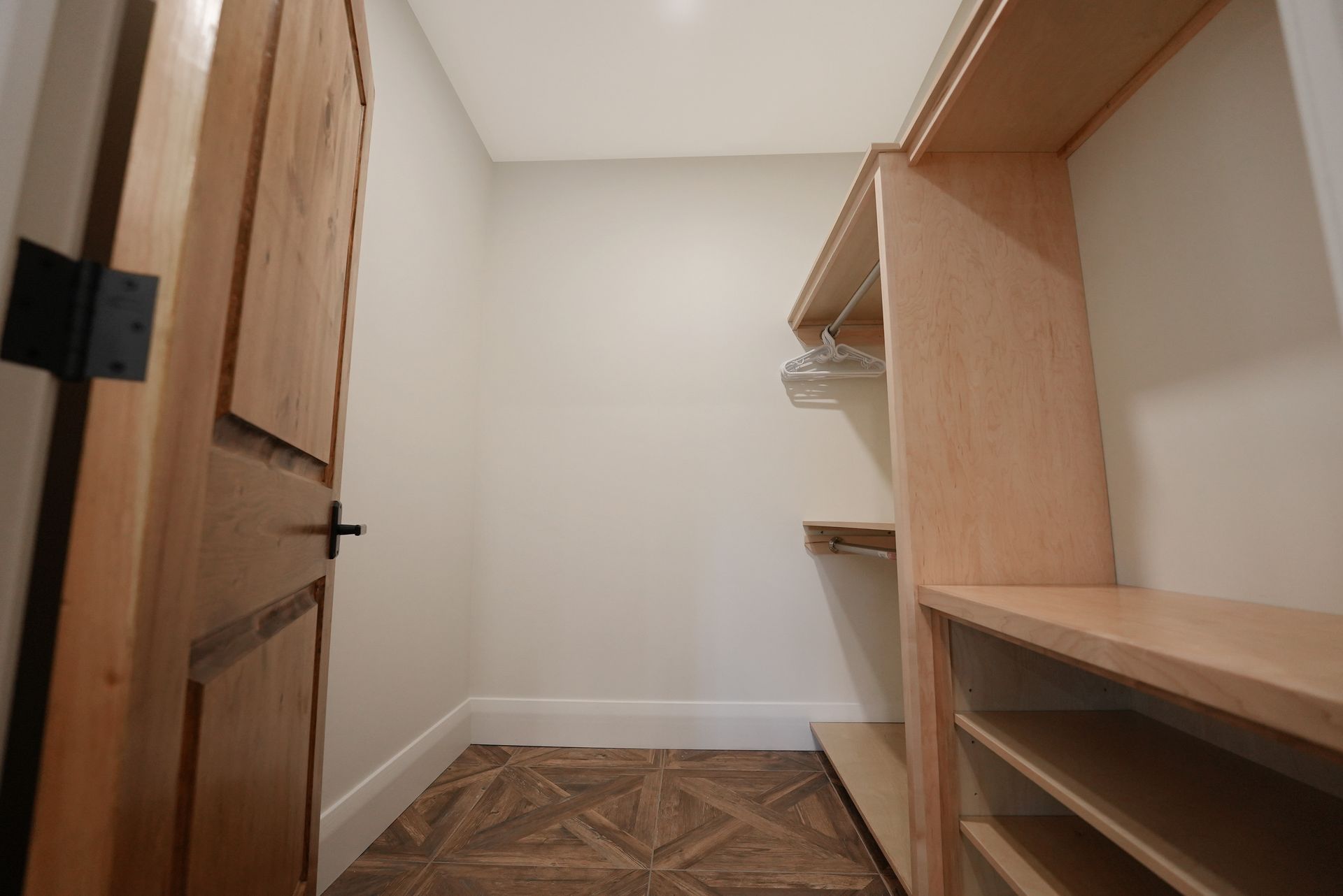 A living room with a lot of windows and a ceiling fan.
