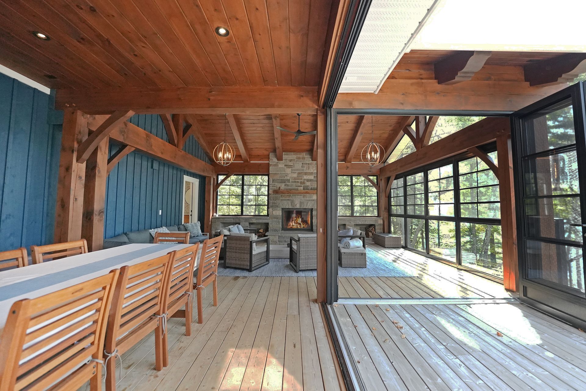 Two pink chairs are sitting on a dock overlooking a lake.