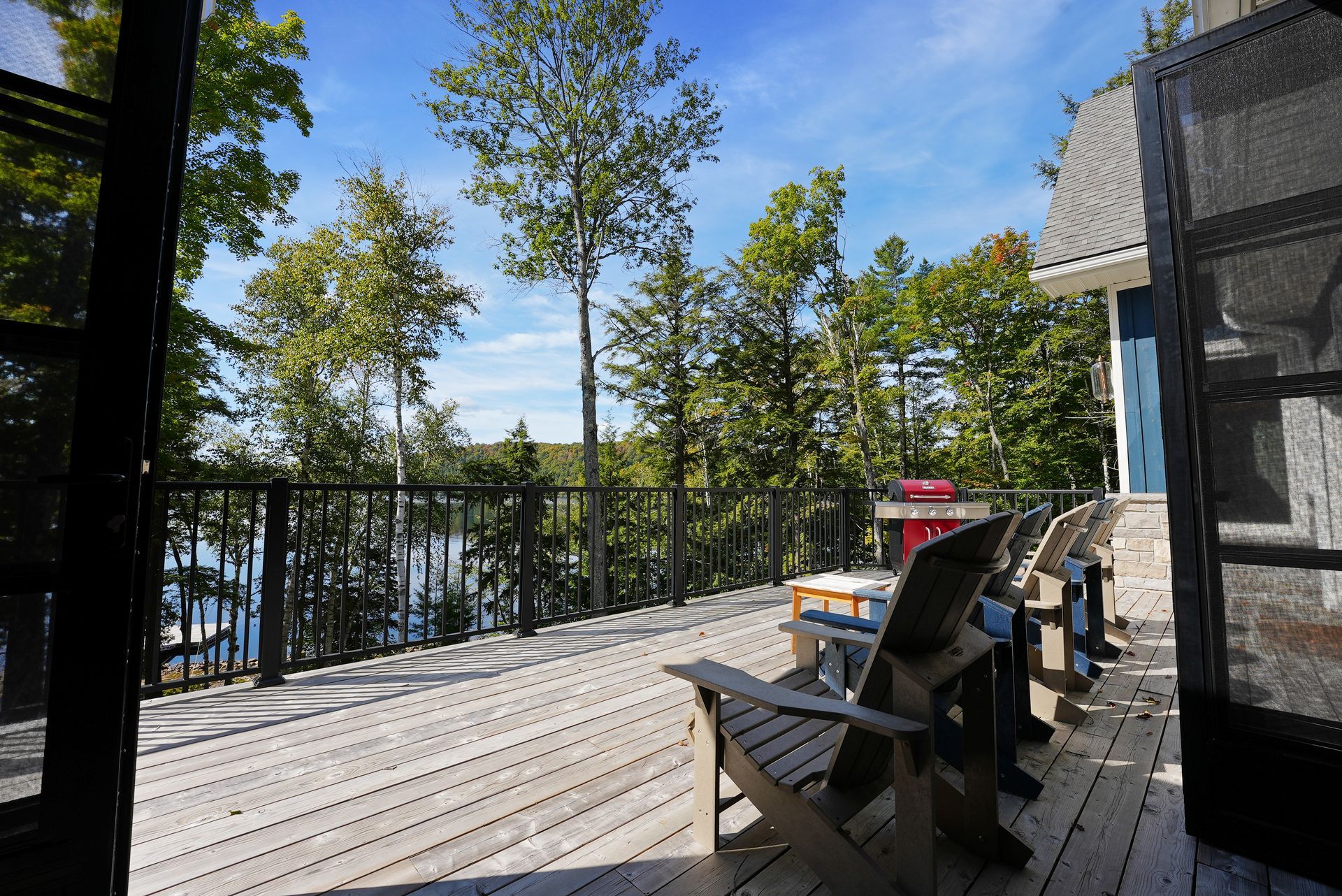 A small house is sitting on the shore of a lake.