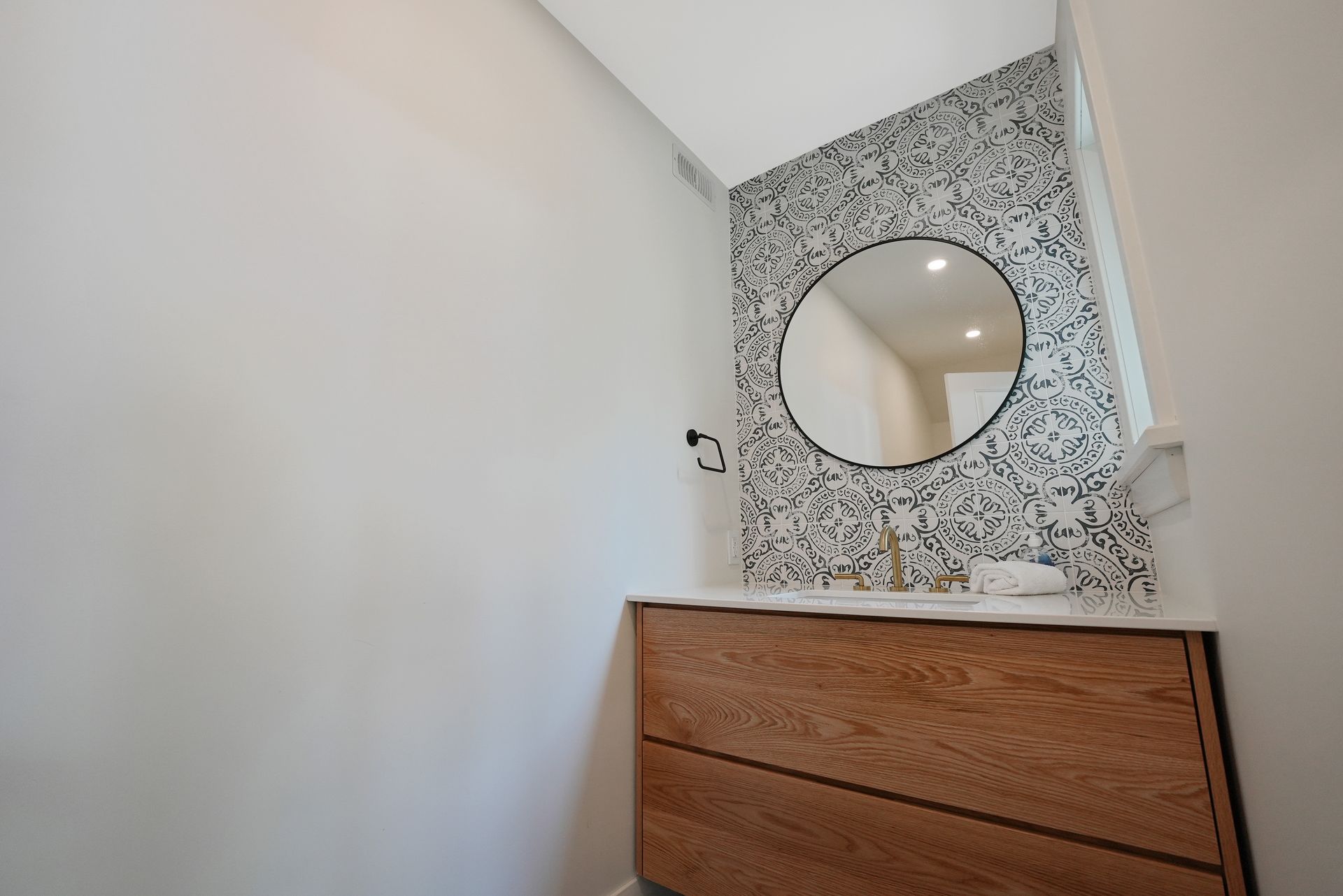 A wooden garage is sitting next to a lake in the woods.