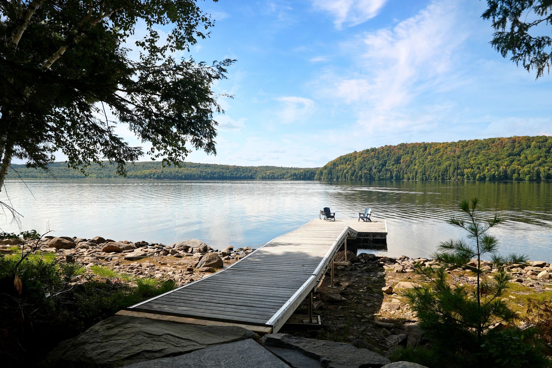 An aerial view of a garage in the middle of a forest.