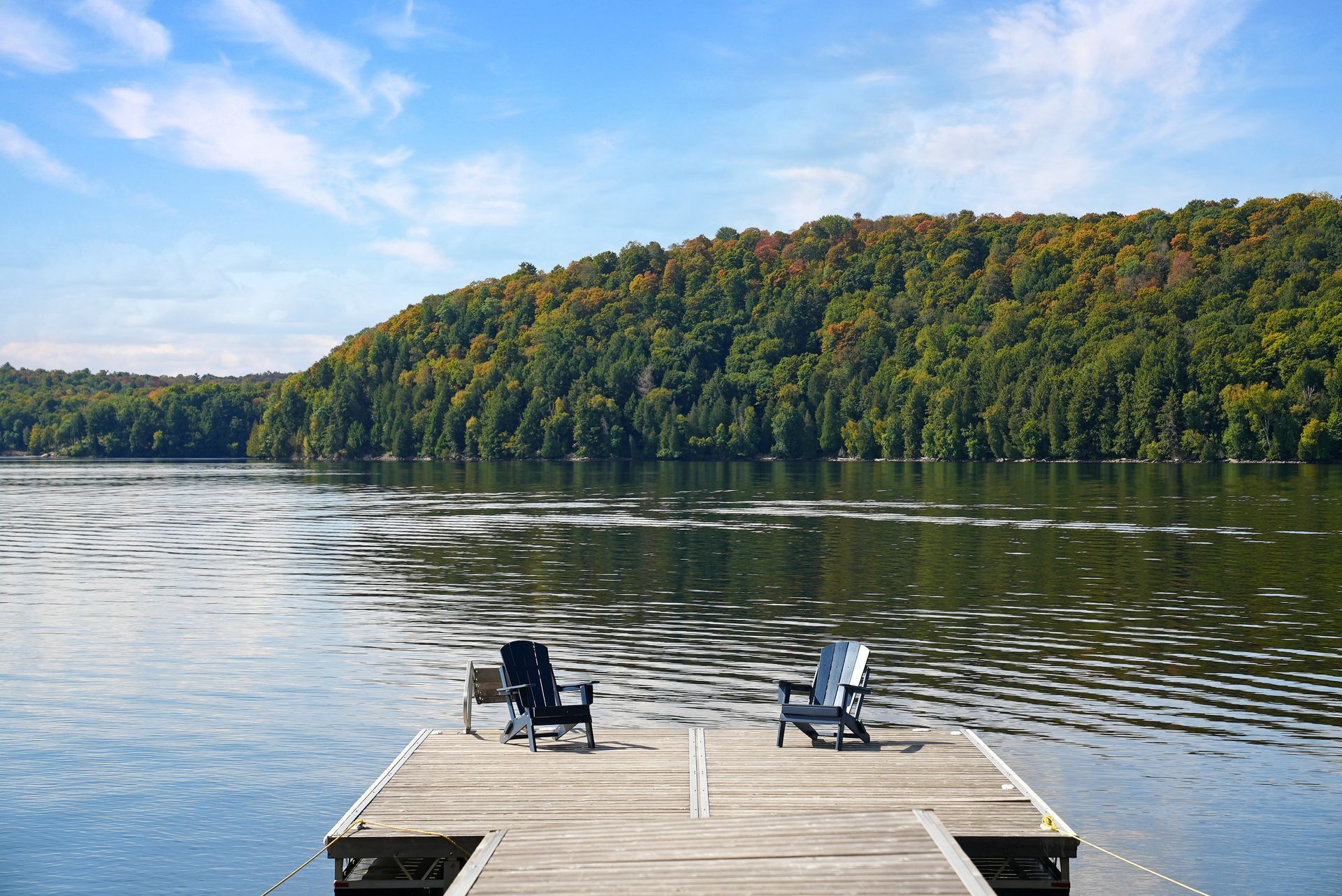 A deck with a table and chairs and an umbrella