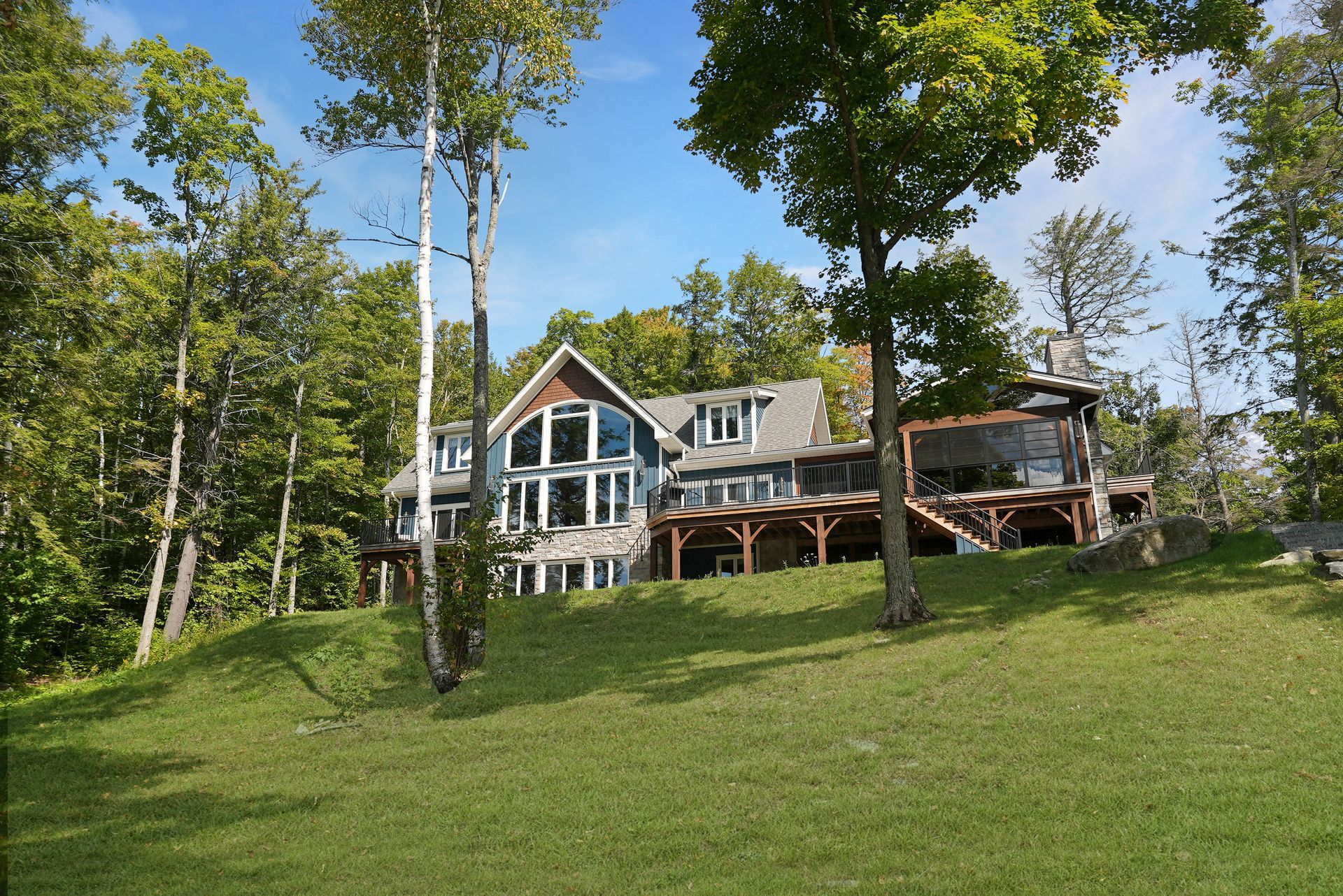 Two boats are docked at a dock next to a house
