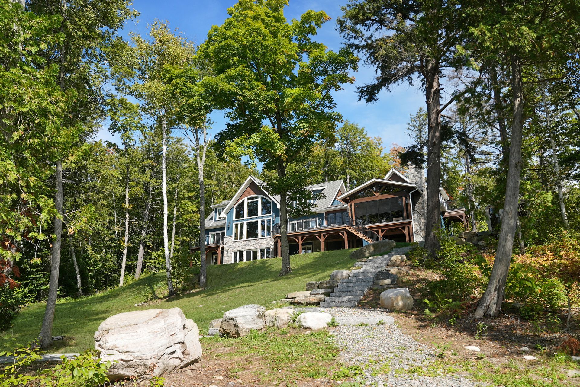 A wooden deck with a view of a lake and trees