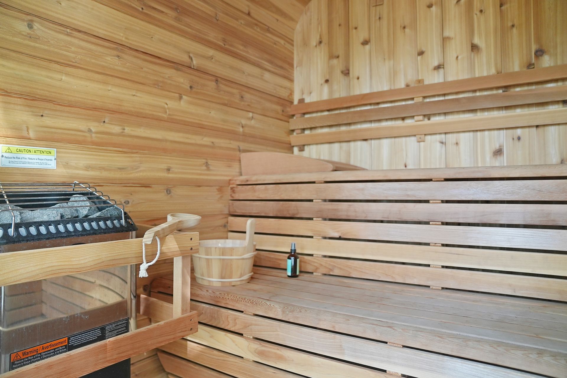 A large deck with a table and chairs and umbrellas.