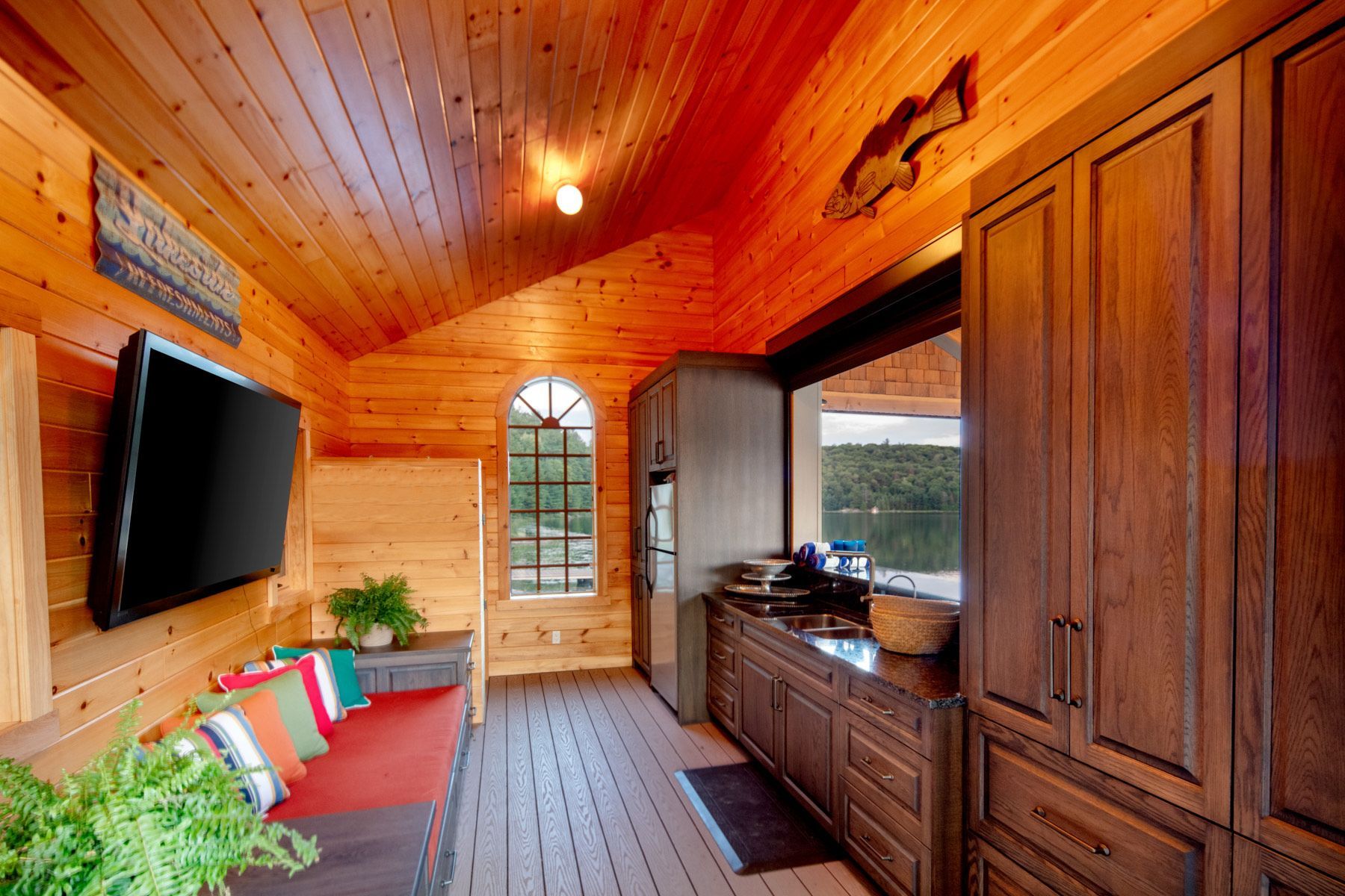 A wooden room with a flat screen tv on the wall.
