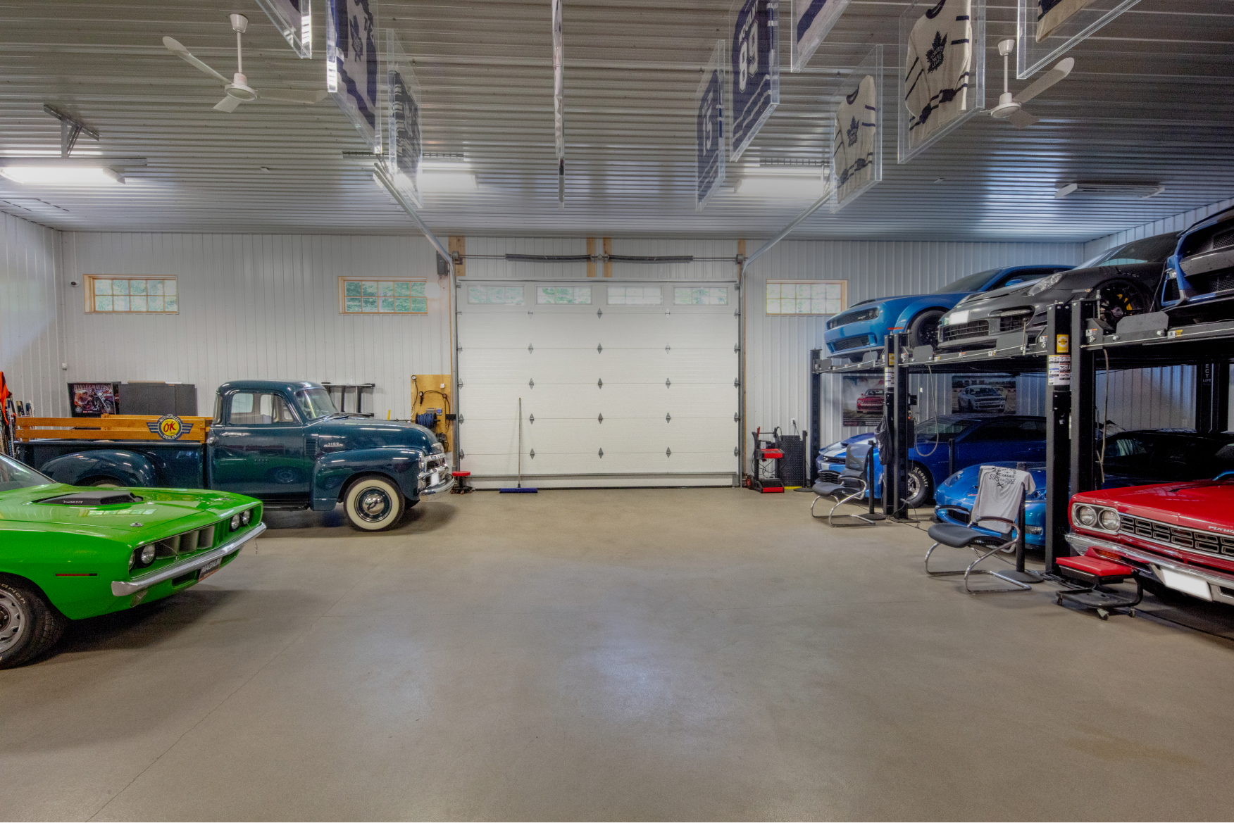 A garage filled with lots of cars and trucks.