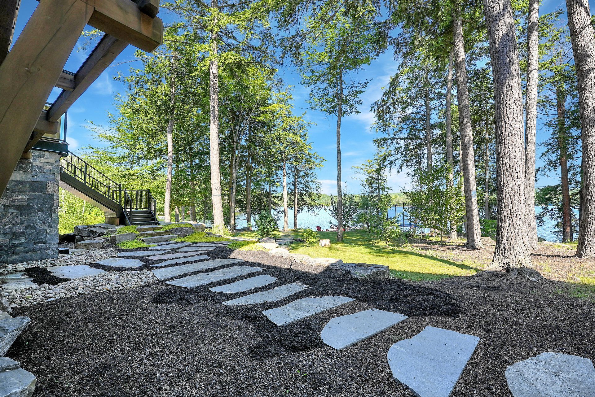 There are two chairs on the porch of a house.
