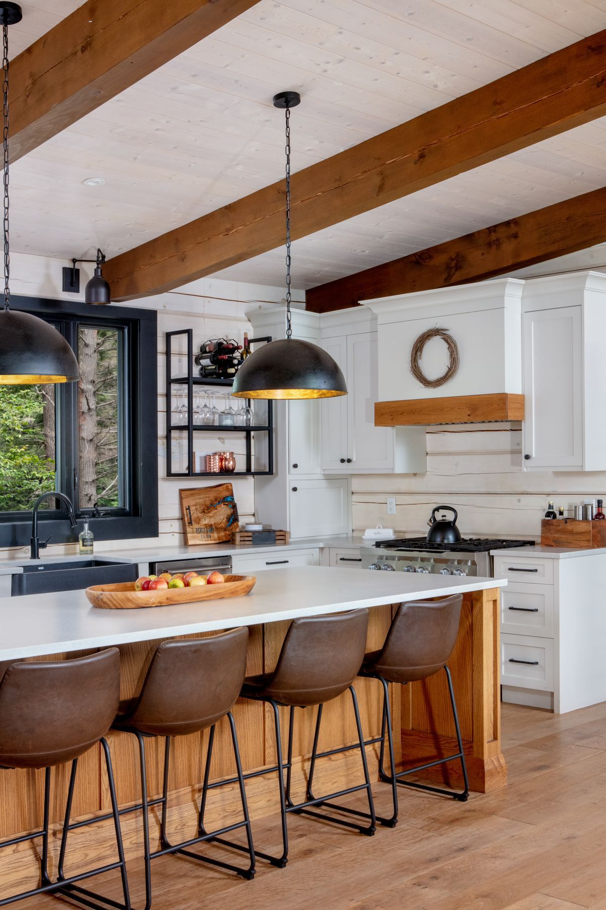 A kitchen with wooden cabinets and a large island