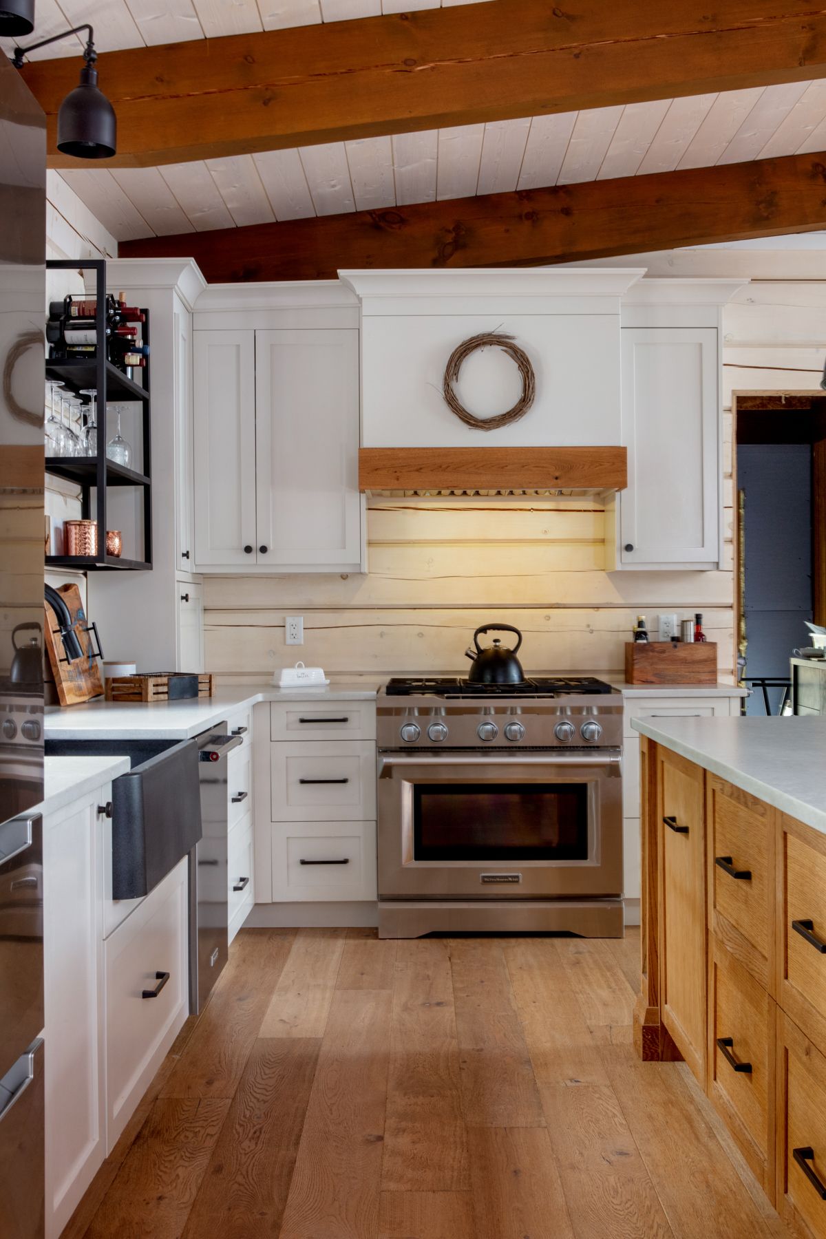 A wood stove is sitting on top of a stone fireplace in a living room.