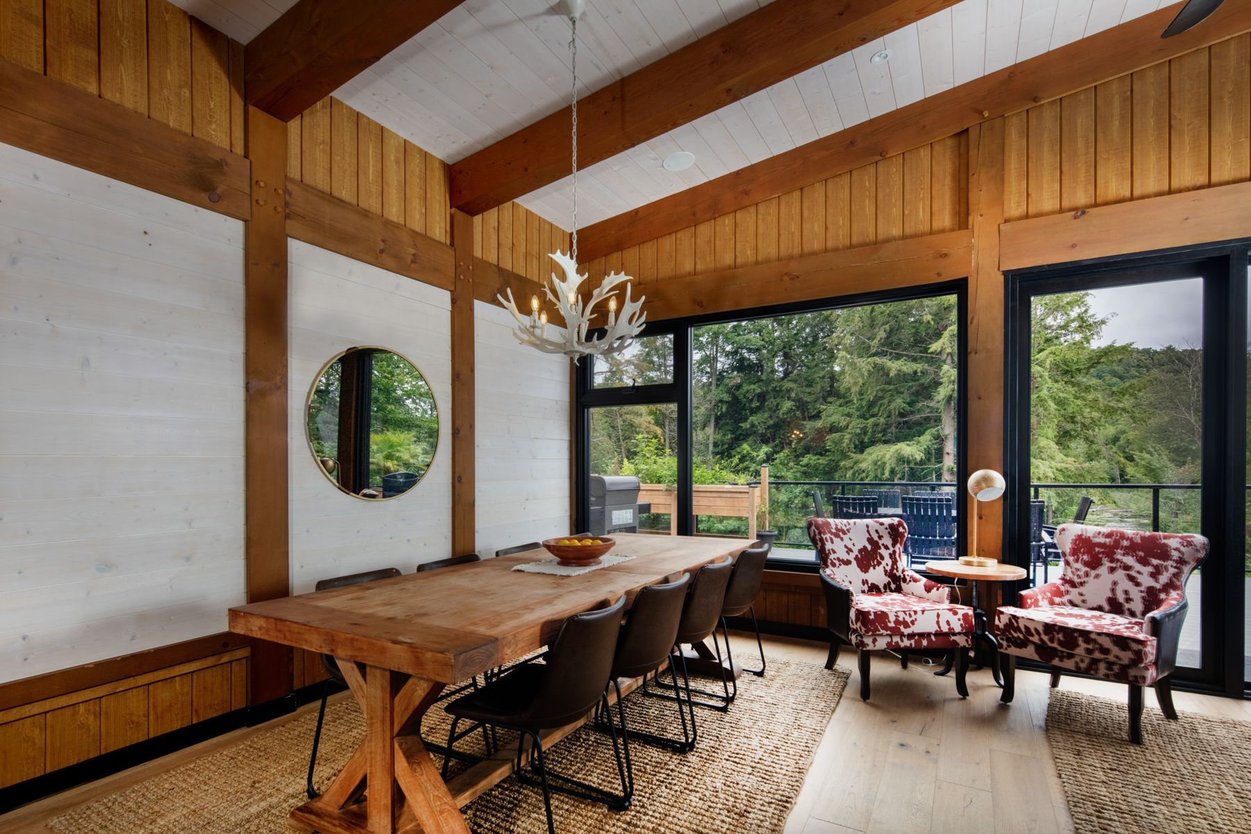 A large dining room with a long wooden table and chairs.