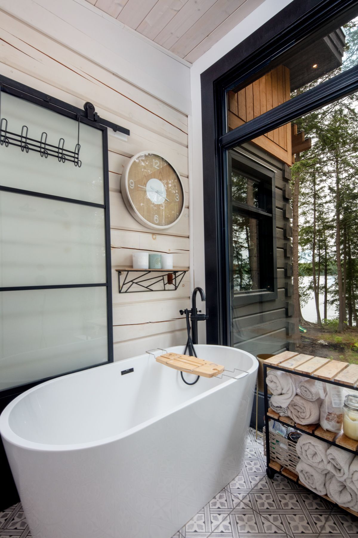 A bathroom with a sink , mirror and light fixtures.