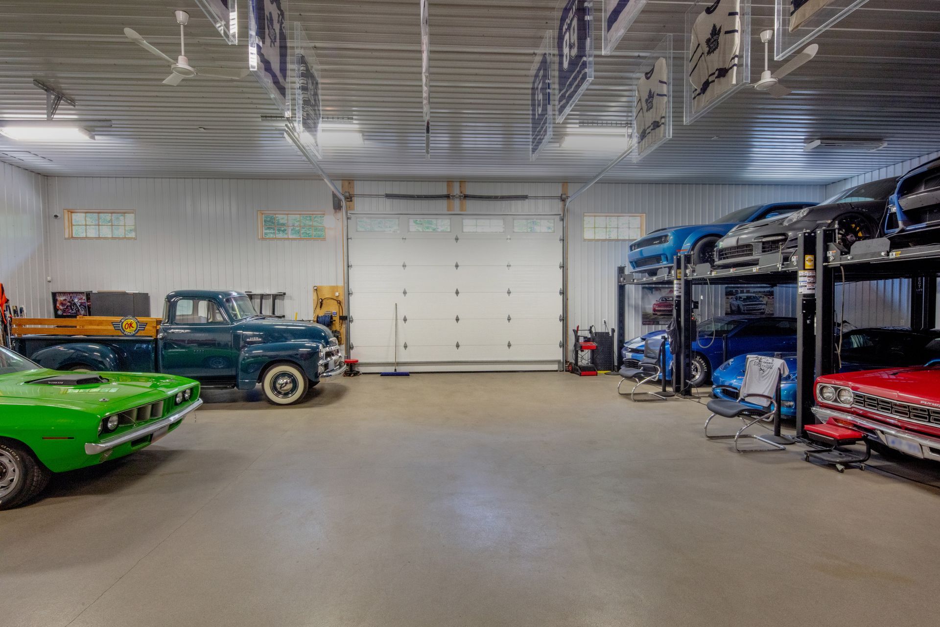A garage filled with lots of cars and trucks.