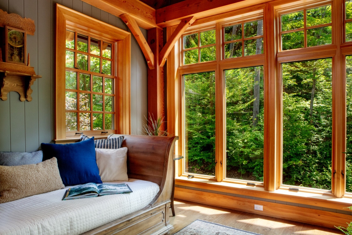 A living room with a couch and lots of windows.