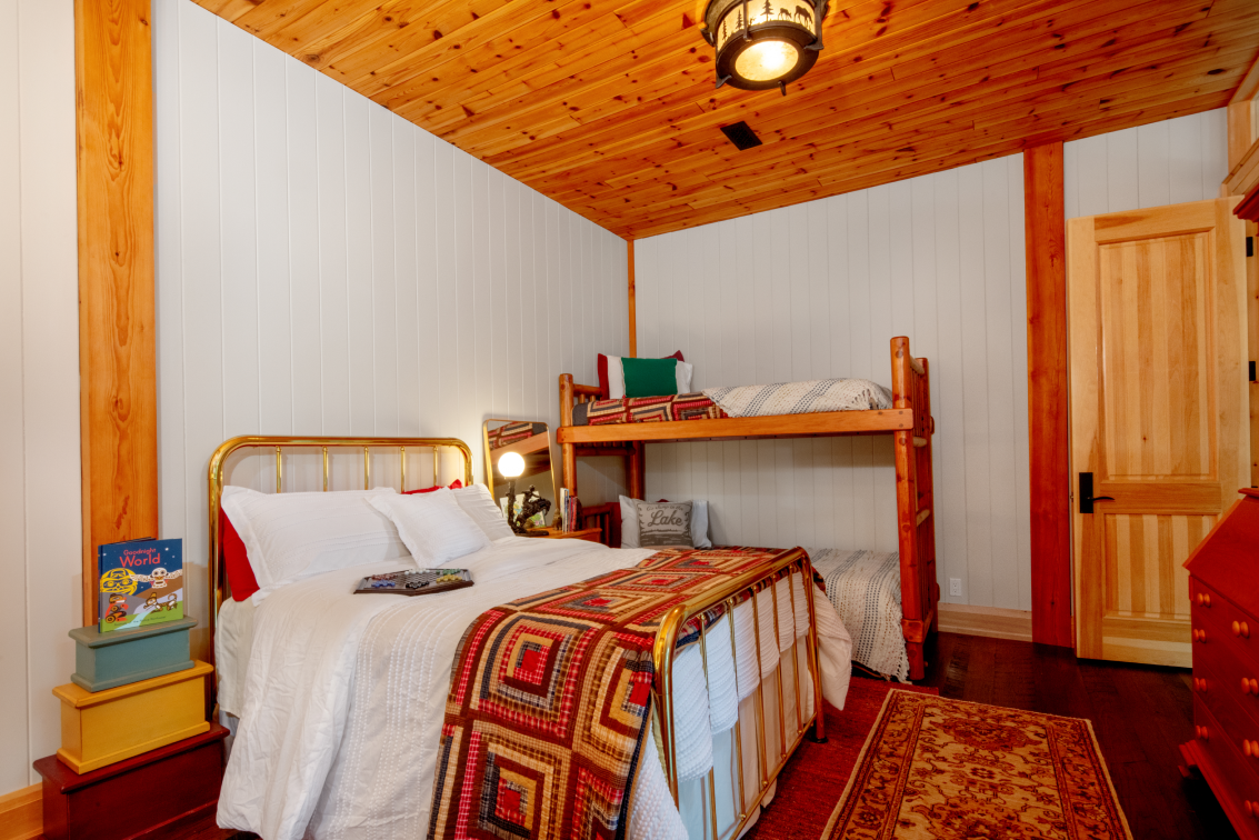 A bedroom with a bunk bed and a bed.