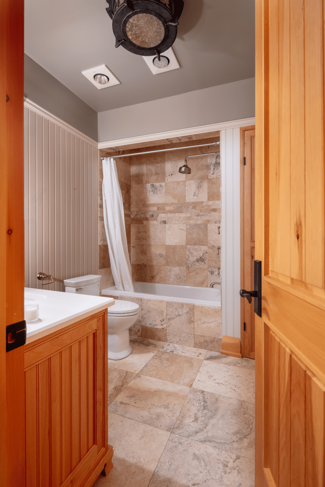 A bathroom with a toilet , sink , tub and shower.