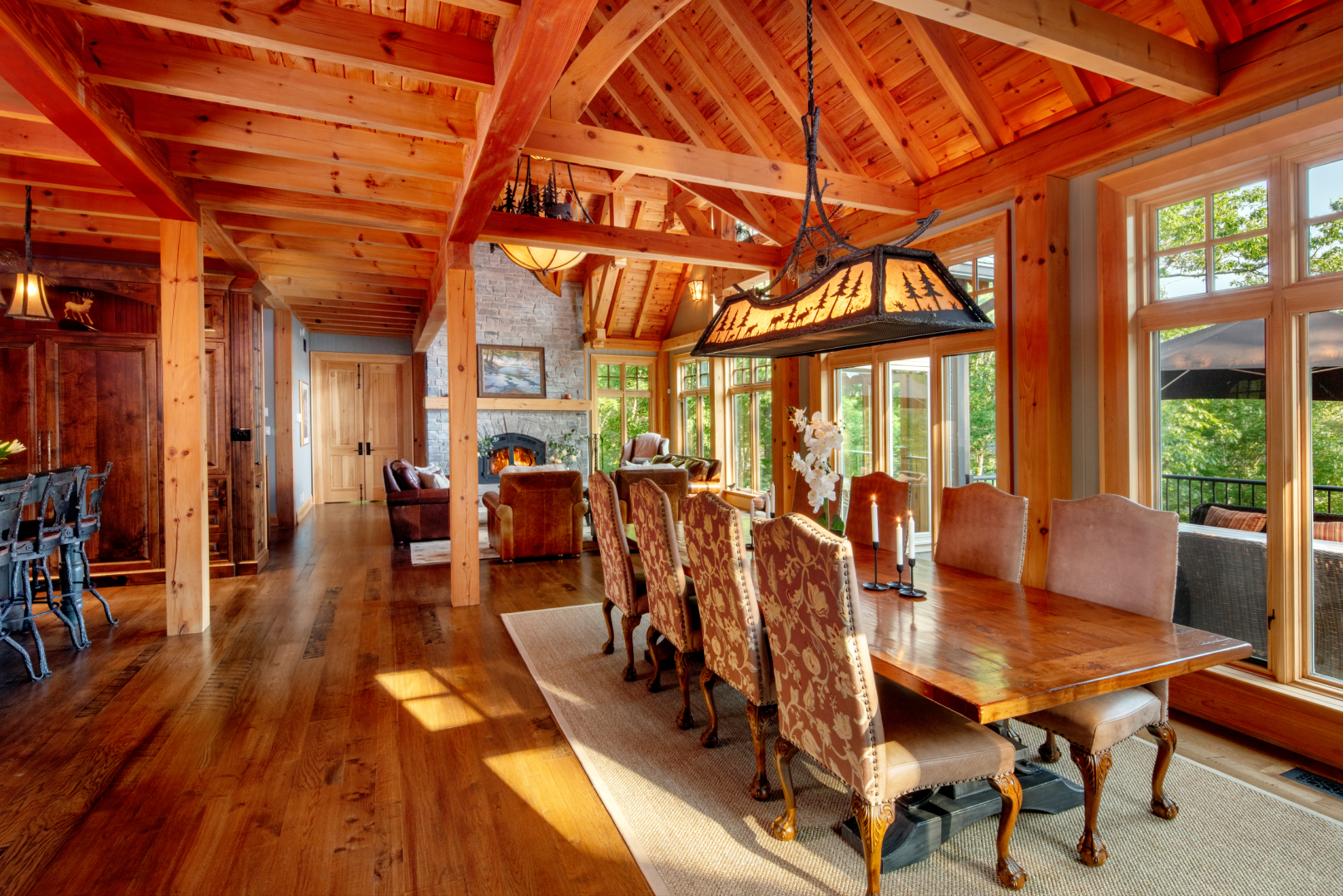 A large dining room with a long wooden table and chairs.