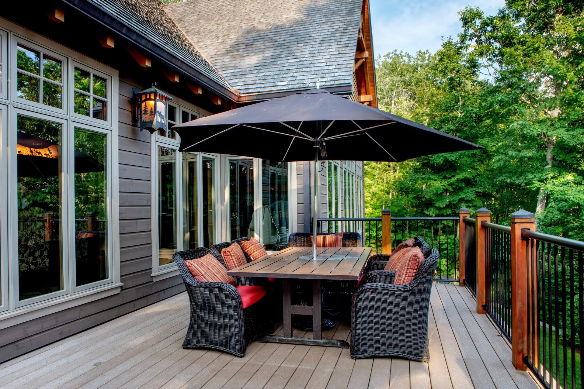 A deck with a table and chairs and an umbrella