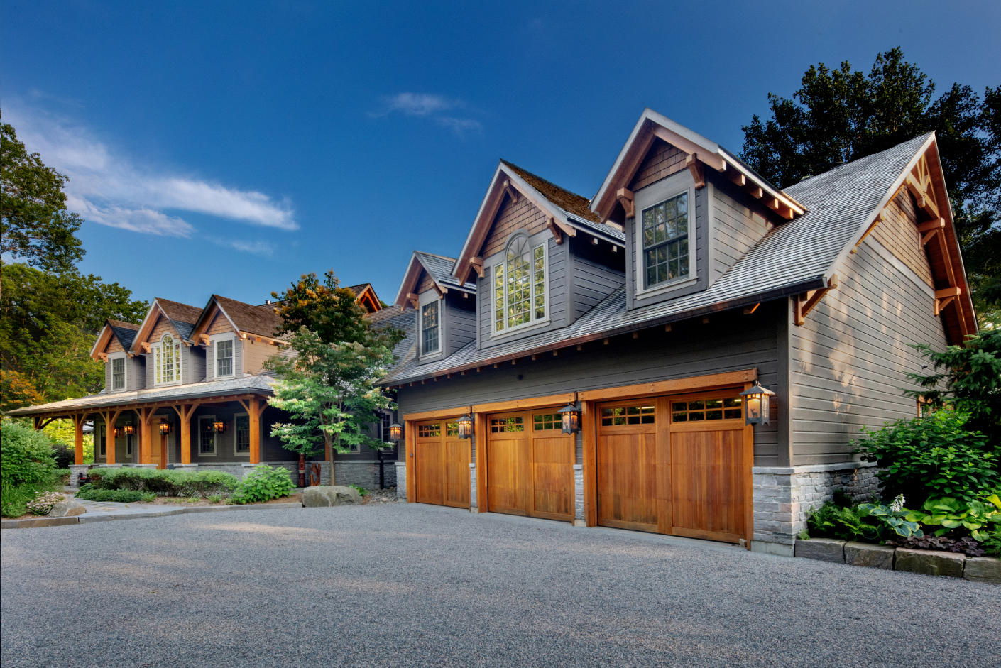 A large house with a row of wooden garage doors