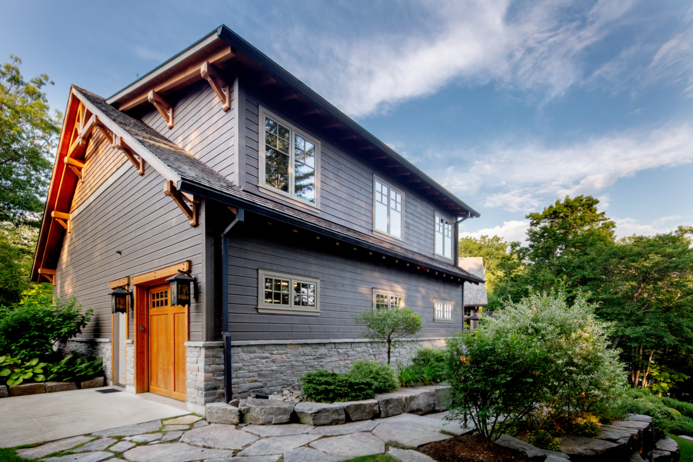 A large house with a lot of windows is surrounded by trees.