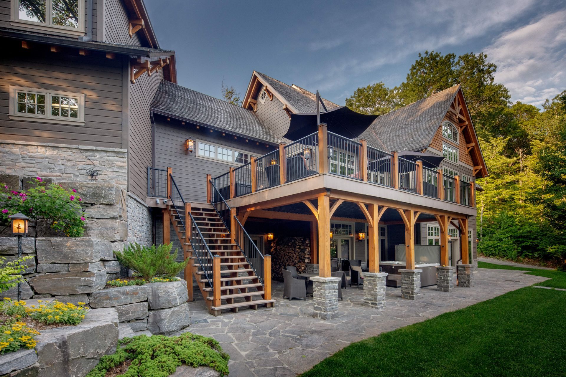 A large house with a large deck and stairs leading up to it.