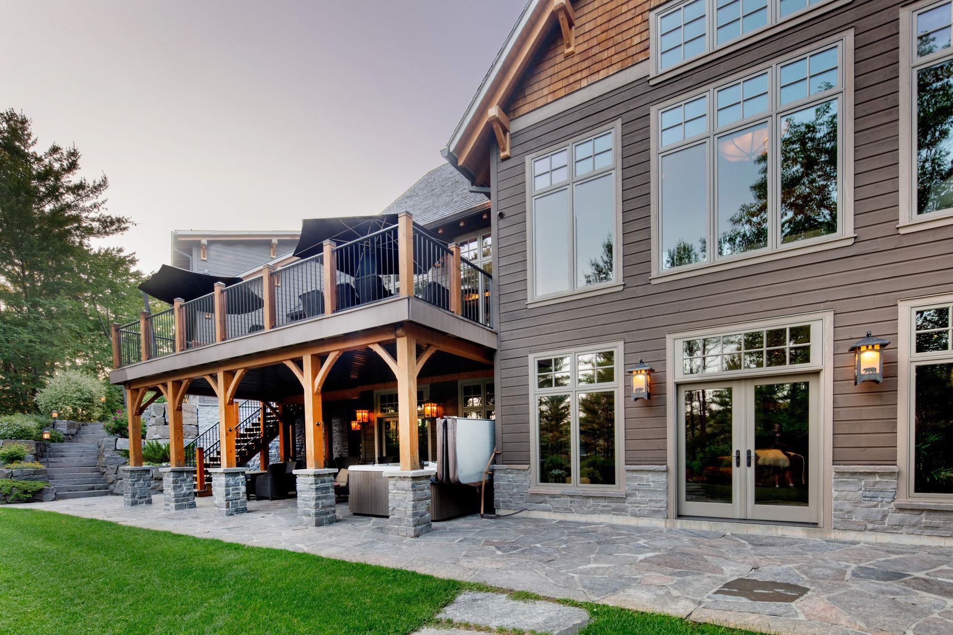 A large house with a large deck and lots of windows