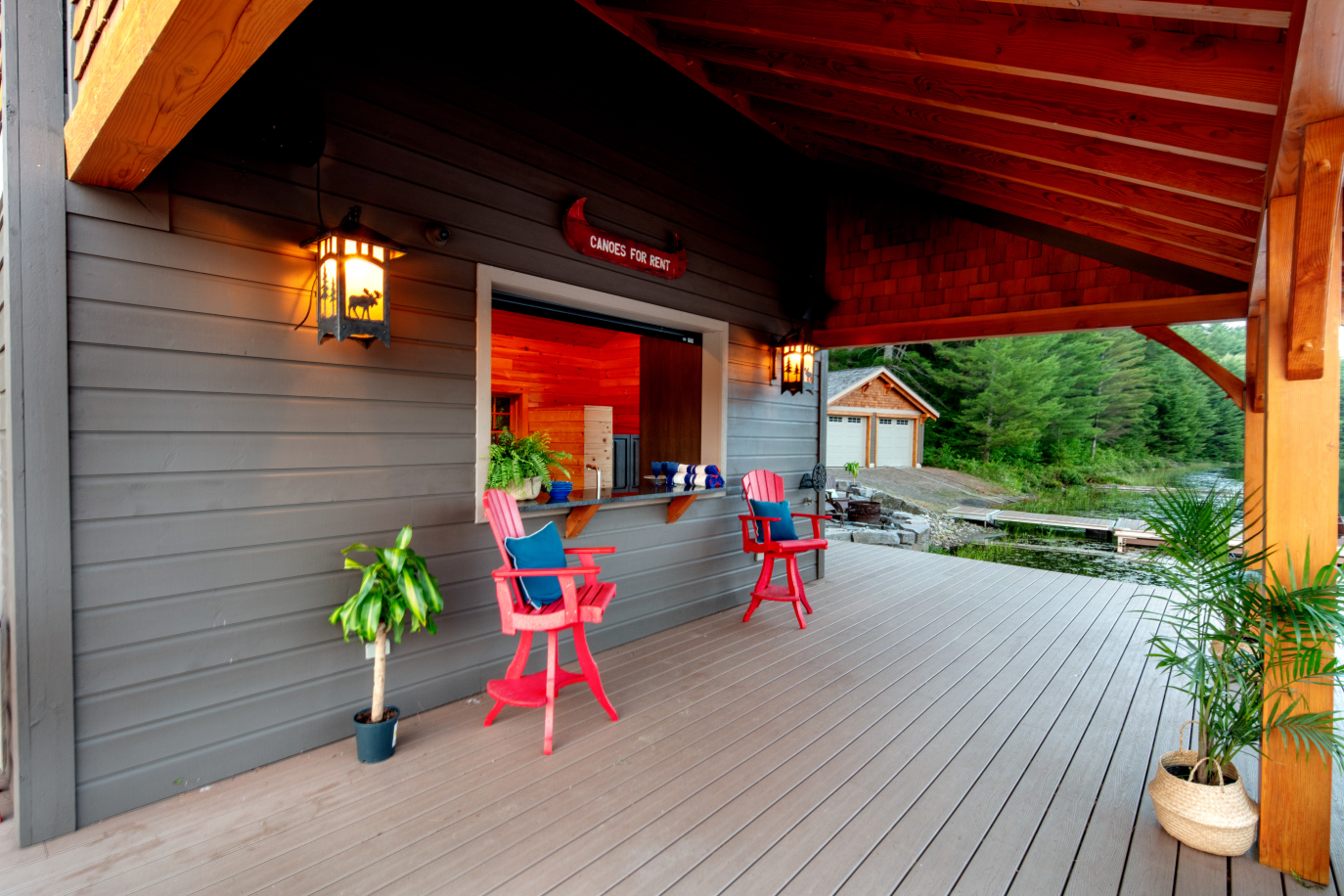 A covered deck with a bar and chairs on it