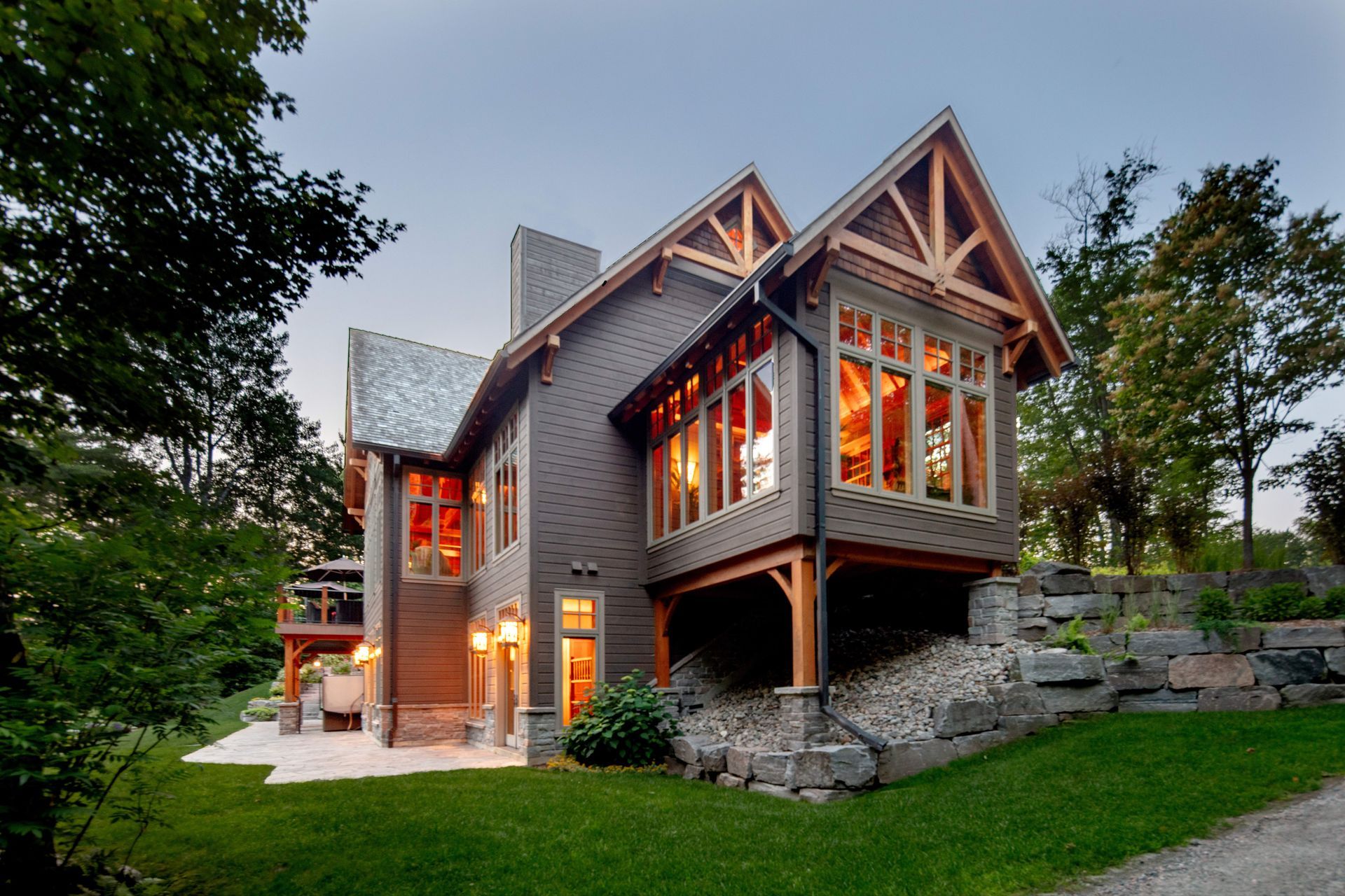 A large house with a lot of windows is surrounded by trees
