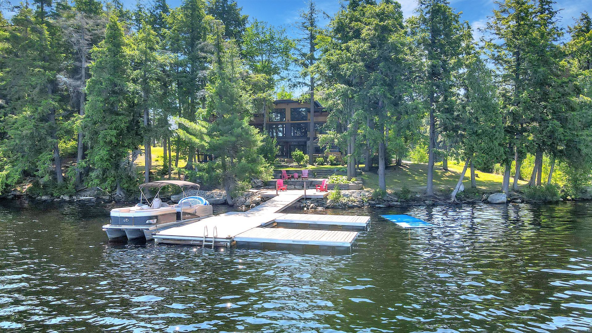 A small shed with a wooden roof is behind a chain link fence.