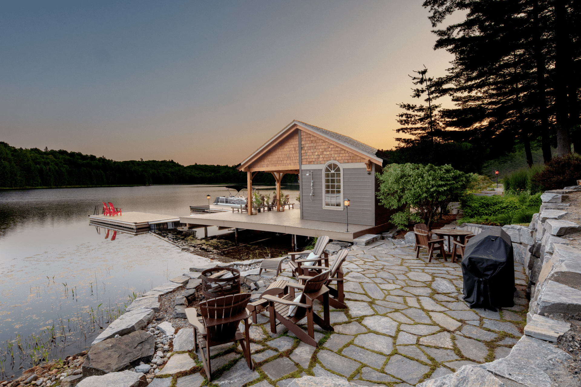 A small house is sitting on the shore of a lake.
