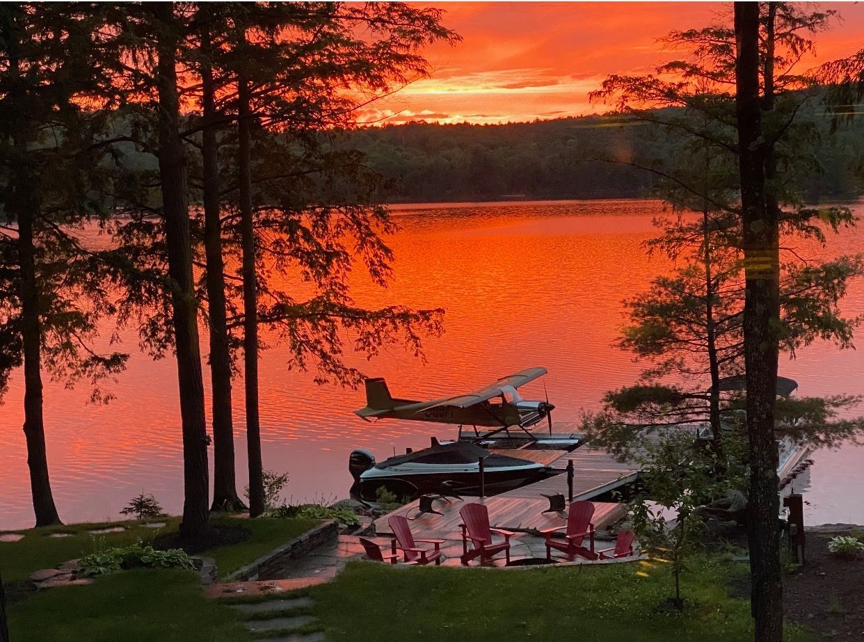 Two boats are docked at a dock next to a house