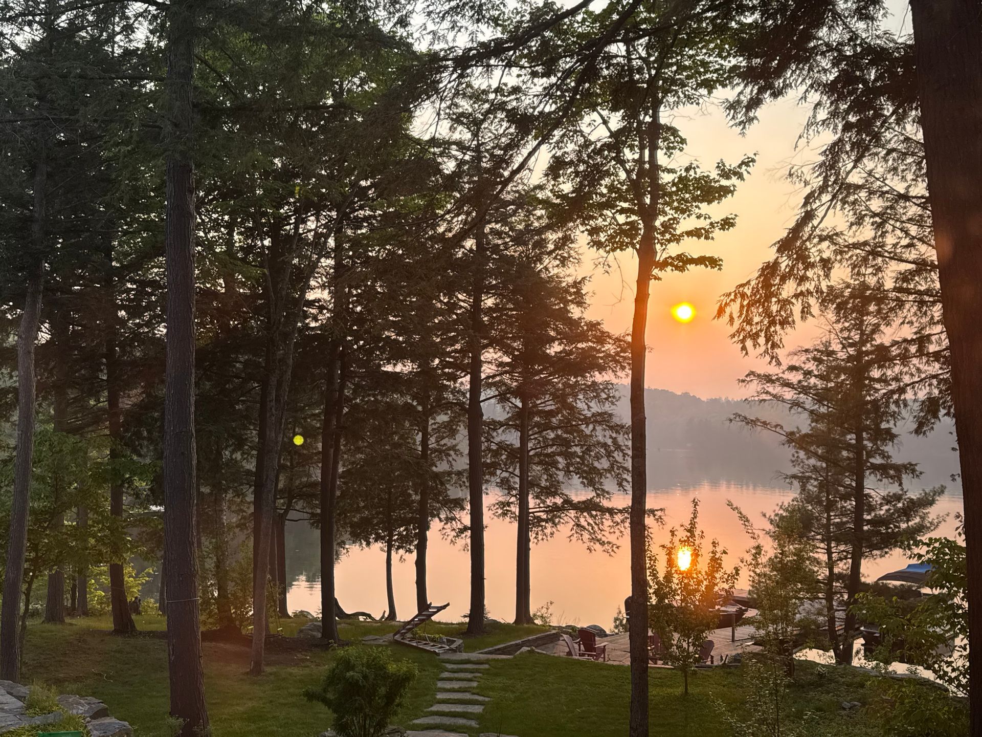 Two chairs are sitting on a deck in front of a building.
