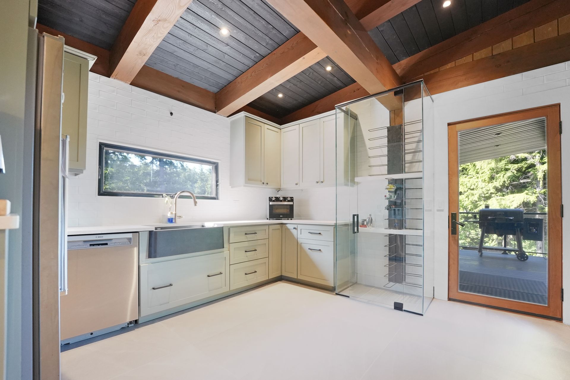 A kitchen with wooden cabinets and a large island