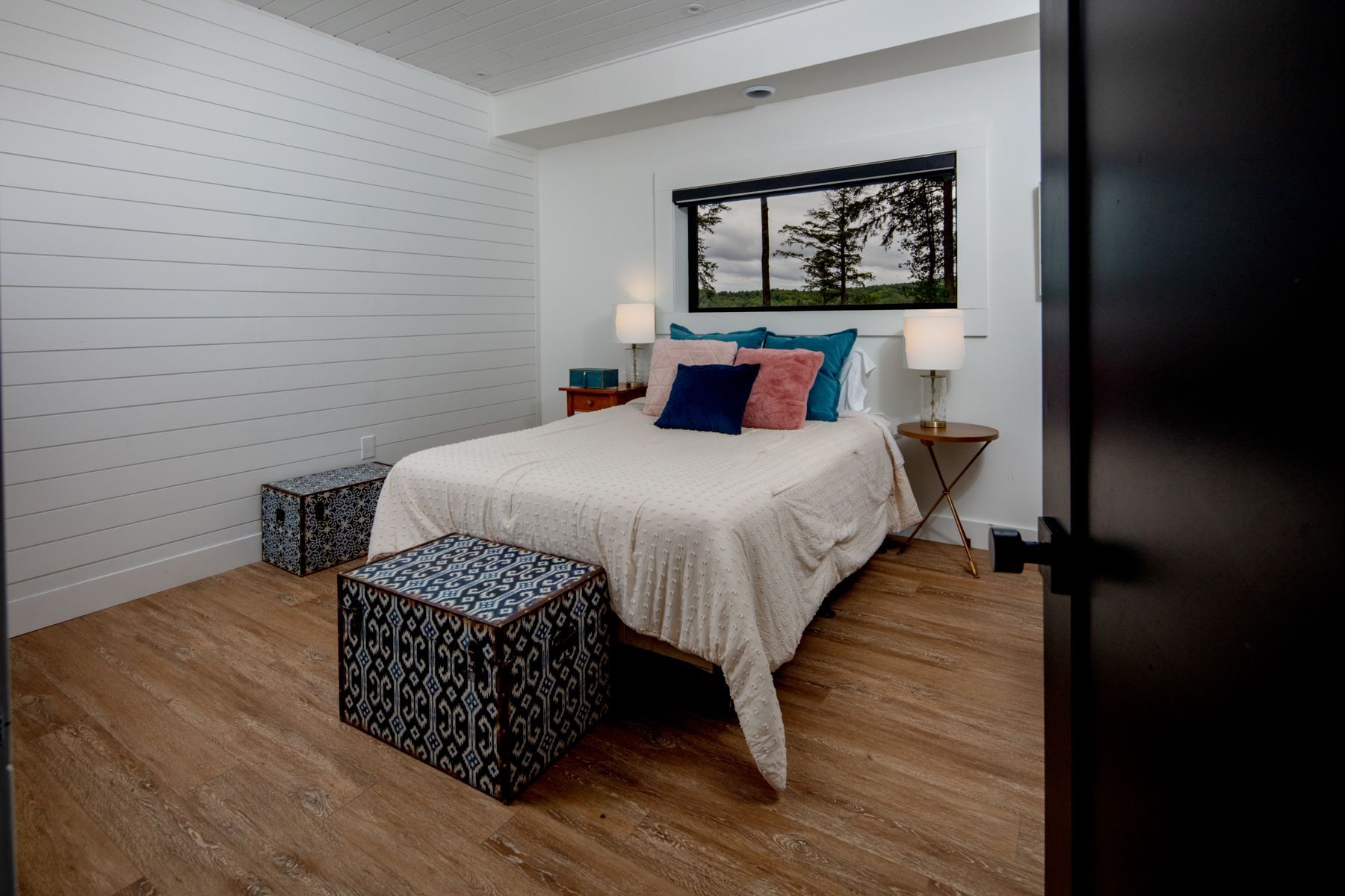 A bedroom with a king size bed and a wooden ceiling.