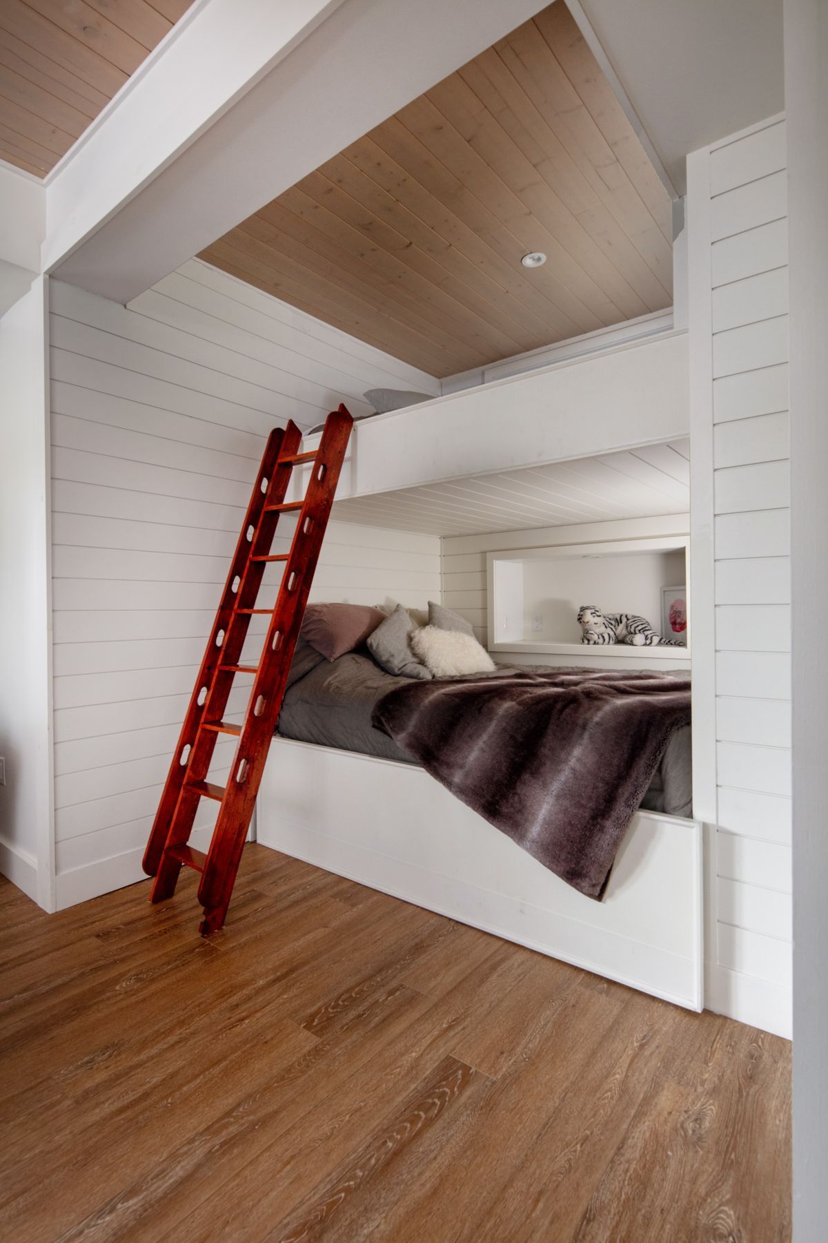 A bathroom with two sinks and a red cabinet