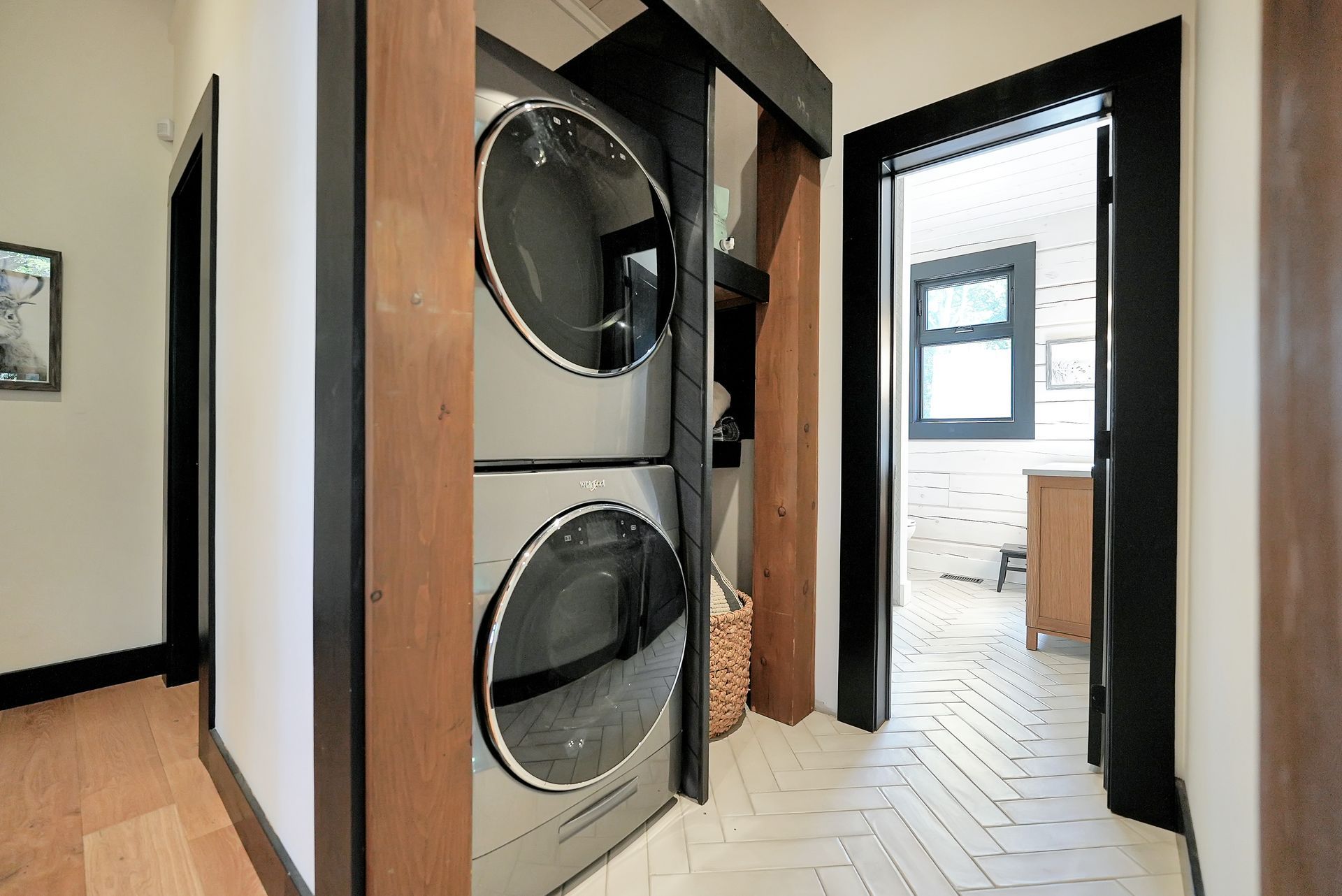 A bathroom with a toilet , sink , mirror and walk in shower.